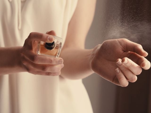 Person applying perfume