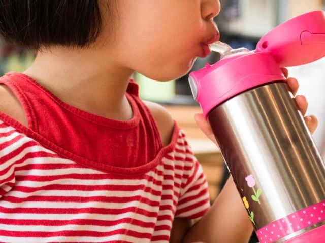 Child drinking from sippy cup