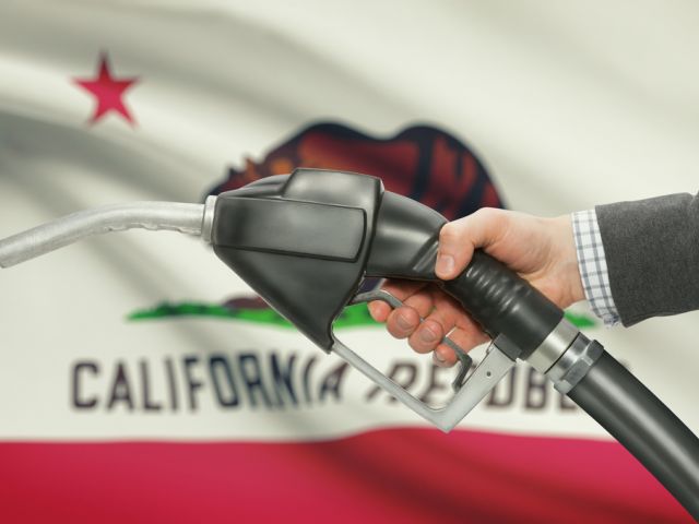 Gas pump in front of California's Flag