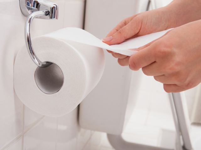Person reaching for toilet paper