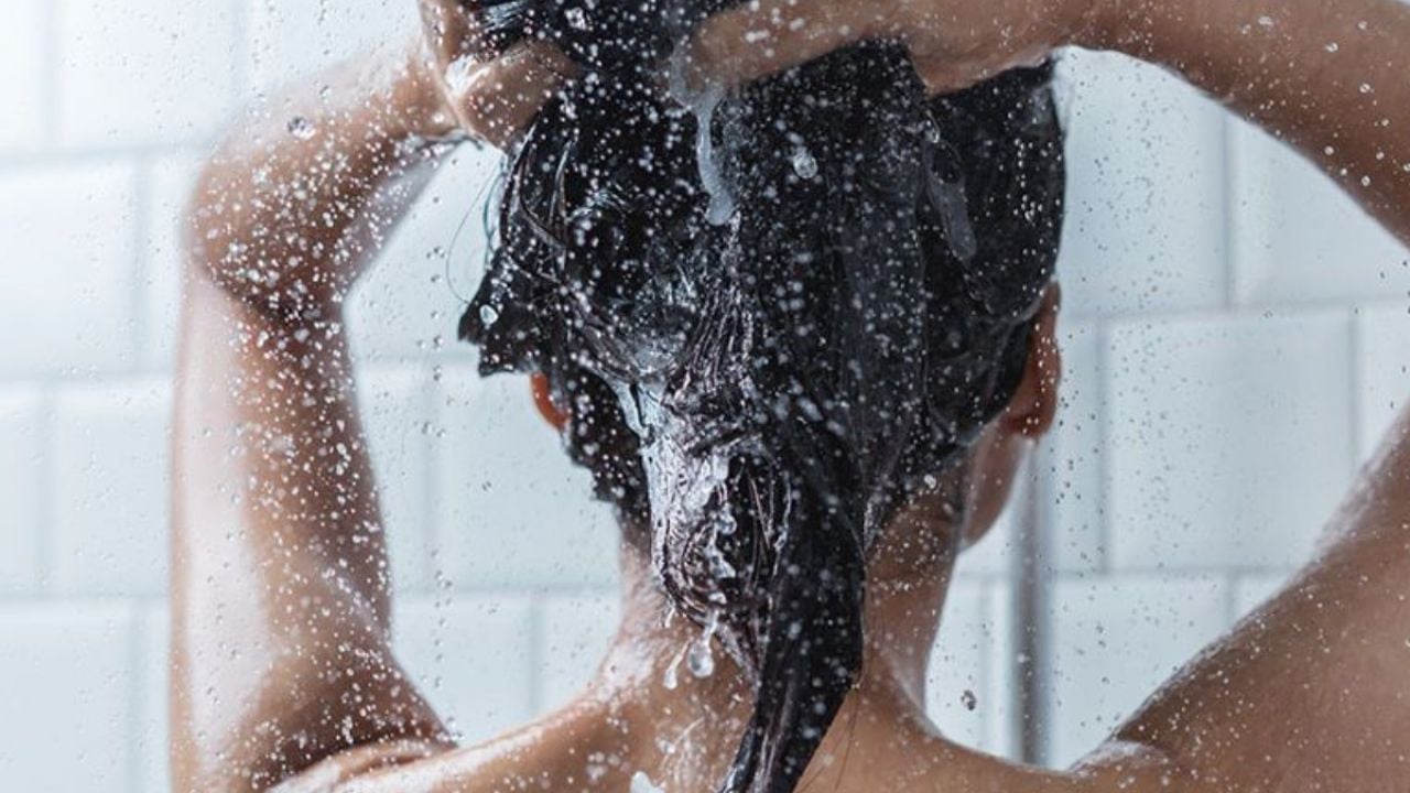 Woman applying shampoo