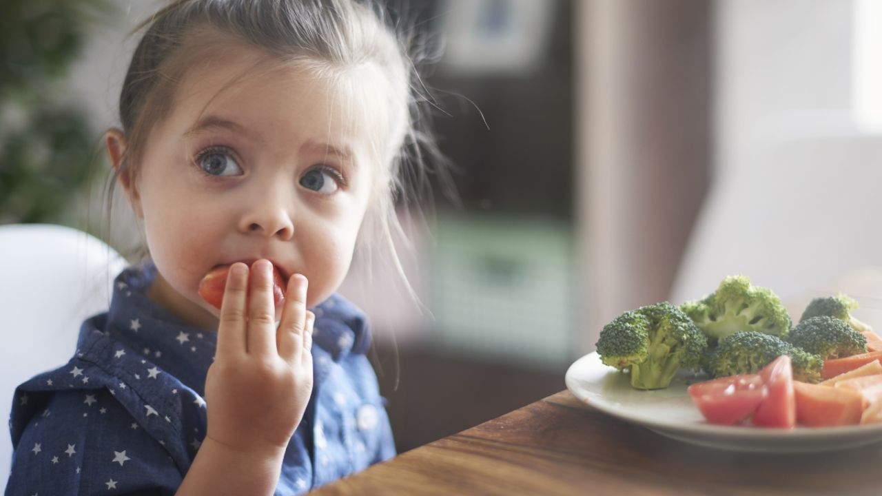 Child eating brocolli