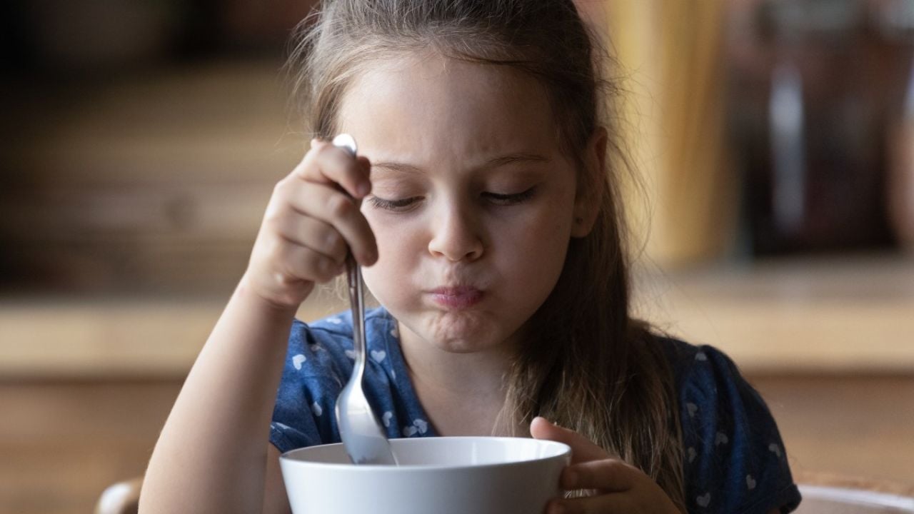 Young girl eating cereal